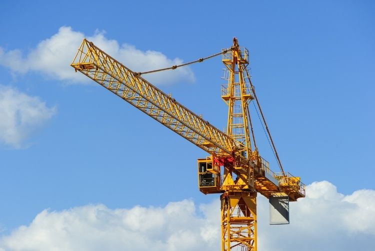 Yellow crane against a blue sky.